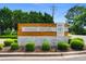 Entrance to Hidden Brooke Neighborhood featuring a monument sign and landscaped greenery at 736 Flowering Branch Ave., Little River, SC 29566