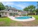 Lush backyard features a beautiful pool, patio area with seating, and a screened-in porch at 78 Oakmont Dr., Pawleys Island, SC 29585