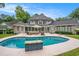Stunning backyard with a sparkling pool, outdoor seating, and well-manicured landscaping at 78 Oakmont Dr., Pawleys Island, SC 29585