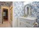 Bathroom featuring blue wallpaper, a white vanity, a shower and an arched mirror at 78 Oakmont Dr., Pawleys Island, SC 29585