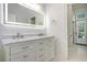 Well-lit bathroom featuring a double sink vanity with marble countertop and shiplap walls at 78 Oakmont Dr., Pawleys Island, SC 29585