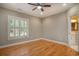 Neutral bedroom showcasing hardwood floors, white trim and a shuttered window at 78 Oakmont Dr., Pawleys Island, SC 29585