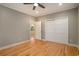 Cozy bedroom featuring hardwood floors, white trim, a ceiling fan and closet at 78 Oakmont Dr., Pawleys Island, SC 29585