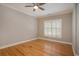 Bright bedroom featuring hardwood floors, neutral walls, white trim and a shuttered window at 78 Oakmont Dr., Pawleys Island, SC 29585