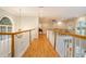 Upstairs hallway with wood floors and a view to a large living area at 78 Oakmont Dr., Pawleys Island, SC 29585