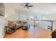 Comfortable living room with hardwood floors, ceiling fan, and many large arched windows at 78 Oakmont Dr., Pawleys Island, SC 29585