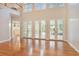 Spacious living room with hardwood floors, high ceilings, and large windows to back yard patio at 78 Oakmont Dr., Pawleys Island, SC 29585