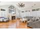 Spacious living room with a fireplace, large windows, vaulted ceiling and comfortable seating at 78 Oakmont Dr., Pawleys Island, SC 29585