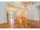 Expansive living area with hardwood floors, fireplace, and large windows offering bright views at 78 Oakmont Dr., Pawleys Island, SC 29585