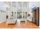 Bright living room with soaring ceilings, large windows, hardwood floors and comfortable seating at 78 Oakmont Dr., Pawleys Island, SC 29585