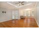 Spacious living room featuring hardwood floors, natural light, and a ceiling fan at 78 Oakmont Dr., Pawleys Island, SC 29585