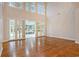 Open living space featuring hardwood floors, tall ceilings, and access to the outdoor patio at 78 Oakmont Dr., Pawleys Island, SC 29585