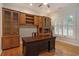 Office with built-in shelves, a large desk, hardwood floors, and plantation shutters at 78 Oakmont Dr., Pawleys Island, SC 29585
