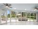 Bright sunroom with panoramic views, tiled floor and ceiling fans at 78 Oakmont Dr., Pawleys Island, SC 29585