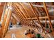 Unfinished attic space showing the support beams and some personal items for storage at 802 Devon Estate Ave., Myrtle Beach, SC 29588