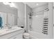 Clean, well-lit bathroom features a shower-tub combo, large mirror and ample counter space at 802 Devon Estate Ave., Myrtle Beach, SC 29588