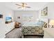 Sunlit bedroom features a ceiling fan, carpet, floral chair and white dresser at 802 Devon Estate Ave., Myrtle Beach, SC 29588