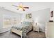 Bright bedroom with a ceiling fan, carpet and green patterned bedding at 802 Devon Estate Ave., Myrtle Beach, SC 29588