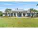 Stunning exterior of the home showcasing its well-manicured lawn, charming facade, and lush palm trees at 802 Devon Estate Ave., Myrtle Beach, SC 29588