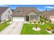 Charming single-Gathering home boasts a well-manicured lawn, attached garage, and inviting entrance at 802 Devon Estate Ave., Myrtle Beach, SC 29588