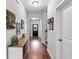 Bright hallway with hardwood floors, decorative accents, and access to various rooms at 802 Devon Estate Ave., Myrtle Beach, SC 29588