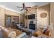 Cozy living room with a stacked stone fireplace, bookshelves, and comfortable seating for relaxation at 802 Devon Estate Ave., Myrtle Beach, SC 29588