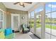 Relaxing sunroom featuring tiled floor, ceiling fan, and sliding glass doors accessing the backyard and pond view at 802 Devon Estate Ave., Myrtle Beach, SC 29588