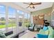 Inviting sunroom with tiled floor, ceiling fan, and sliding glass doors overlooking the peaceful backyard and pond view at 802 Devon Estate Ave., Myrtle Beach, SC 29588