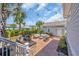 Landscaped backyard with outdoor seating, barbecue area, string lights and palm trees at 8185 Sandlapper Way, Myrtle Beach, SC 29572