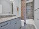 Stylish bathroom with a granite vanity, shower-tub combo, and elegant fixtures, offering a luxurious experience at 8185 Sandlapper Way, Myrtle Beach, SC 29572