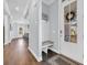 Cozy entryway with welcome sign, bench, and natural light from the front door at 8185 Sandlapper Way, Myrtle Beach, SC 29572