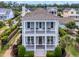 Charming two-story home featuring double porches, columns, and manicured landscaping at 8185 Sandlapper Way, Myrtle Beach, SC 29572