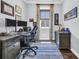 Well-appointed home office with a large desk, built-in storage, and a bright window for a productive workspace at 8185 Sandlapper Way, Myrtle Beach, SC 29572