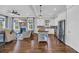 Open living area featuring a fireplace, a kitchen island, stainless steel appliances, and hardwood floors at 8185 Sandlapper Way, Myrtle Beach, SC 29572