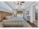 Beautiful main bedroom featuring a tray ceiling, large windows, and a spacious layout with a decorative dresser at 8185 Sandlapper Way, Myrtle Beach, SC 29572