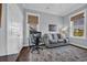 A calm office space featuring a comfortable sofa and bright, sunny windows at 8185 Sandlapper Way, Myrtle Beach, SC 29572