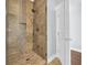 Modern shower with tile surround, bronze fixtures and glass door at 8185 Sandlapper Way, Myrtle Beach, SC 29572
