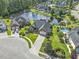 Stunning aerial view of a brick home with pool overlooking a serene lake in a lush community at 8204 Caddis Ct., Myrtle Beach, SC 29579