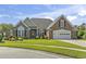 Charming single-story brick home with a well-manicured lawn, attached garage, and tasteful landscaping at 8204 Caddis Ct., Myrtle Beach, SC 29579