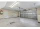 Spacious garage with storage racks, overhead door, and epoxy flooring for convenient parking and organization at 8204 Caddis Ct., Myrtle Beach, SC 29579