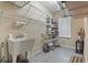 Well-lit utility room with sink, ample shelving, and storage solutions for organization and convenience at 8204 Caddis Ct., Myrtle Beach, SC 29579