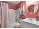 Bright bathroom with white vanity, fish themed mirror, and tub and shower combination at 843 Villa Dr. # 843, North Myrtle Beach, SC 29582
