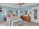 Bright bedroom is well-lit with a ceiling fan and lamps, and features an inviting, soothing coastal design at 843 Villa Dr. # 843, North Myrtle Beach, SC 29582