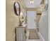 Entryway features a wooden cabinet with decorative lamp, mirror and front door at 843 Villa Dr. # 843, North Myrtle Beach, SC 29582