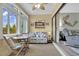 Bright sunroom features a coastal theme with a table, chairs, sofa, and sliding glass doors to living space at 843 Villa Dr. # 843, North Myrtle Beach, SC 29582