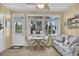Sunroom boasts a table and chairs and large windows offering plenty of natural light at 843 Villa Dr. # 843, North Myrtle Beach, SC 29582