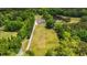 Aerial view of a home surrounded by mature trees and a tranquil pond at 856 W Highway 9, Longs, SC 29568