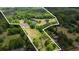 Aerial view of property, highlighting land boundaries, house, pond, and surrounding greenery at 856 W Highway 9, Longs, SC 29568