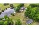 Aerial view of the property showcasing the home, a private lake, pool, and surrounding landscape at 856 W Highway 9, Longs, SC 29568