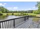 Enjoy scenic views of the private lake from the home's relaxing back deck area at 856 W Highway 9, Longs, SC 29568